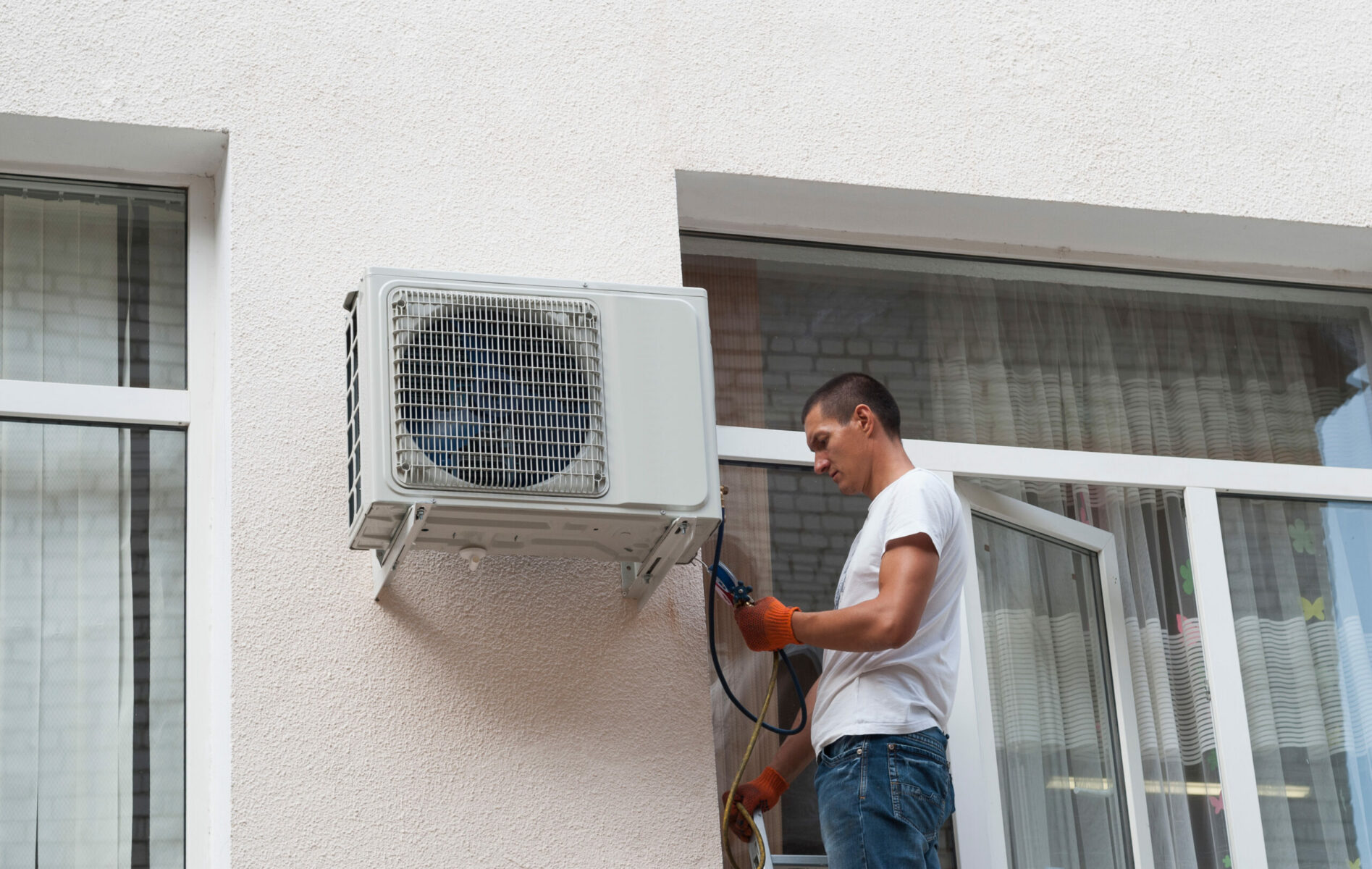 Worker,Installs,The,Outdoor,Unit,Of,The,Air,Conditioner